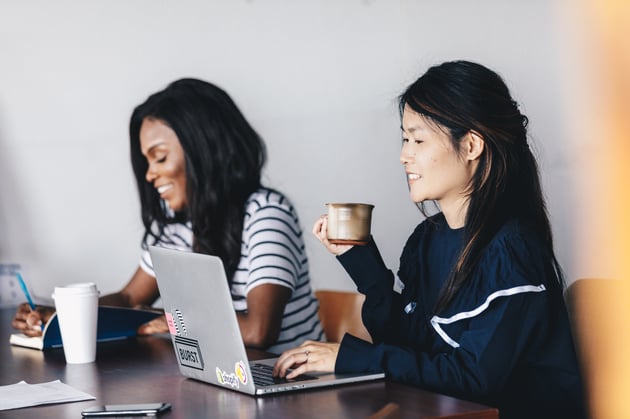 women-sat-during-a-meeting-while-enjoying-a-coffee